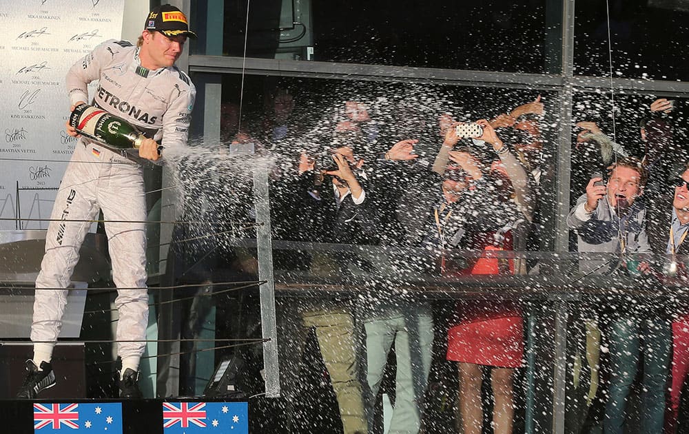 Mercedes driver Nico Rosberg of Germany sprays champagne in celebration after winning the Australian Formula One Grand Prix at Albert Park in Melbourne.