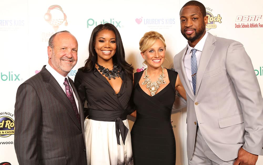 Ron Book, Chairman of Lauren`s Kids, Gabrielle Union, Lauren Book, Founder and CEO of Lauren`s Kids and Dwyane Wade, of the Miami Heat, attend the 8th Annual Reid & Fiorentino Call of the Game Dinner Presented by Publix at the Seminole Hard Rock Hotel & Casino in Hollywood, Fla.