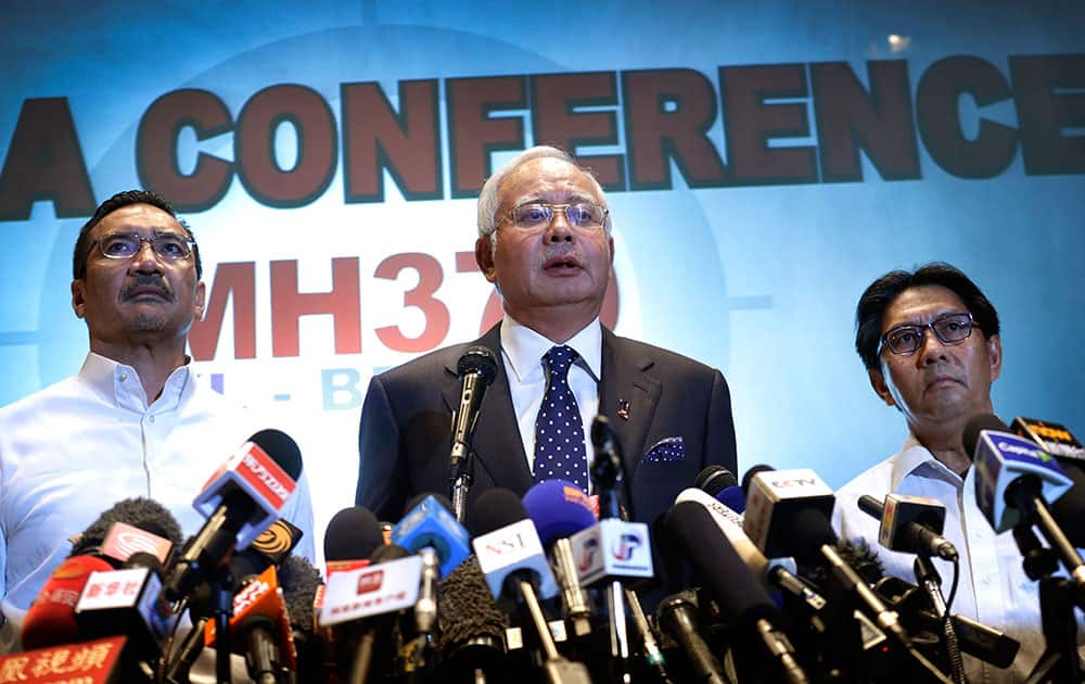 Malaysian Prime Minister Najib Razak, Malaysia`s minister for transport Hishamuddin Hussein and director general of the Malaysian Department of Civil Aviation, Azharuddin Abdul Rahman, delivers a statement to the media regarding missing Malaysia Airlines jetliner MH370, Saturday, March 15, 2014 in Sepang, Malaysia.