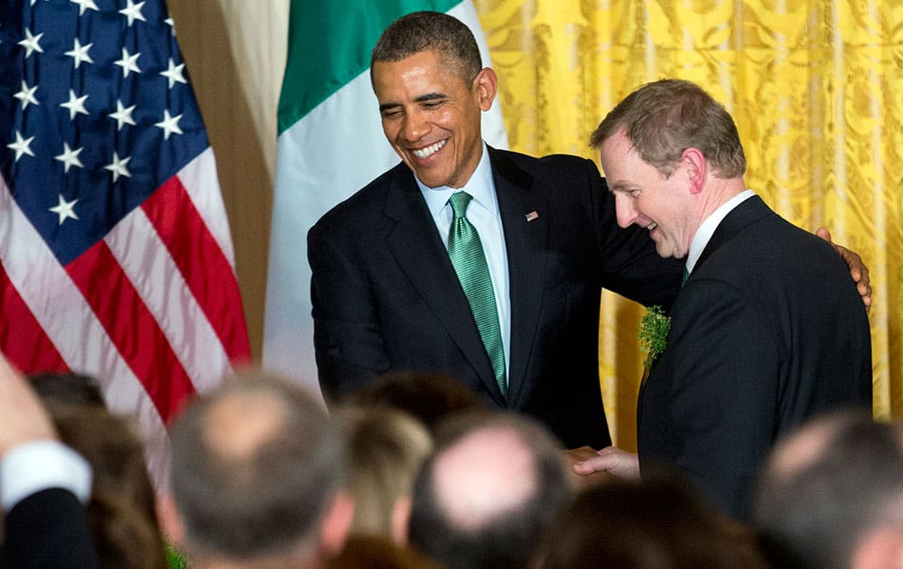 President Barack Obama, left, shakes hands with Irish Prime Minister Enda Kenny, during a St. Patrick’s Day reception in the East Room of the White House in Washington.