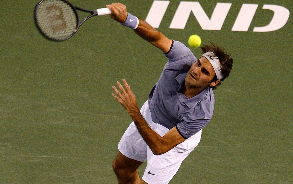 Roger Federer, of Switzerland, serves to Kevin Anderson, of South Africa, during their quarterfinal match at the BNP Paribas Open tennis tournament in Indian Wells, Calif.