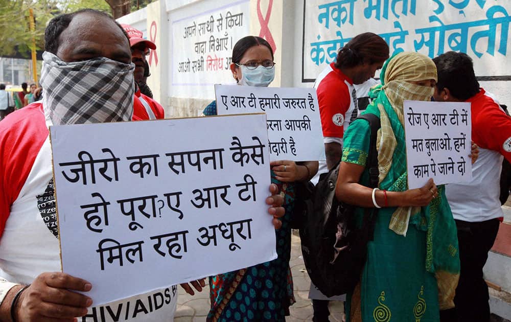 HIV affected patients display placards outside the Maharashtra State AIDS Control Society during a protest for the shortage of HIV medicines in Mumbai.
