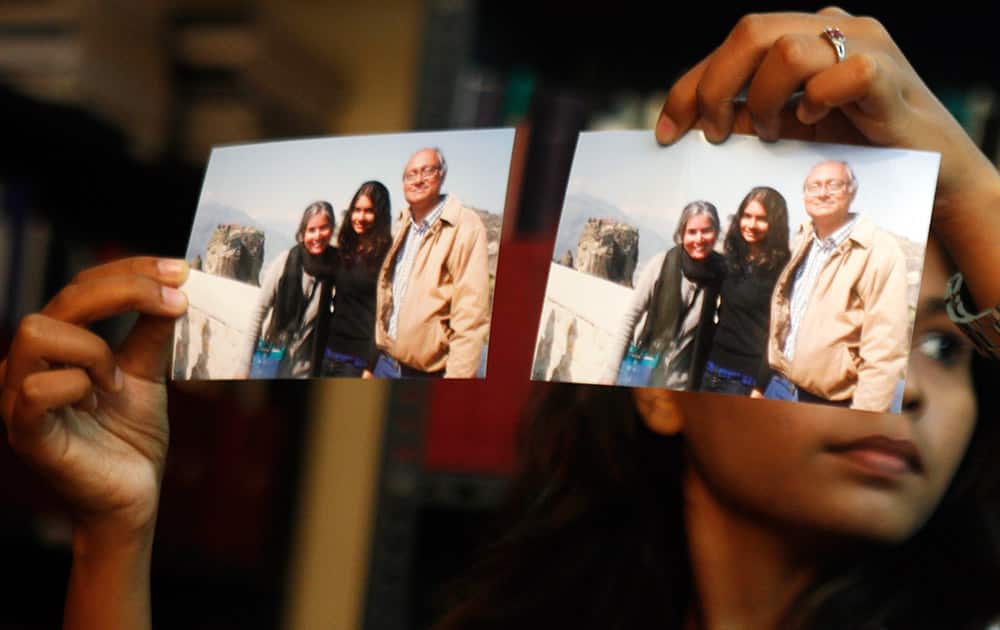 Photographs showing one of the passengers of the missing Malaysian Airlines aircraft Chandrika Sharma, left, her husband Narendran and daughter Meghna, are displayed during a press conference in Chennai.
