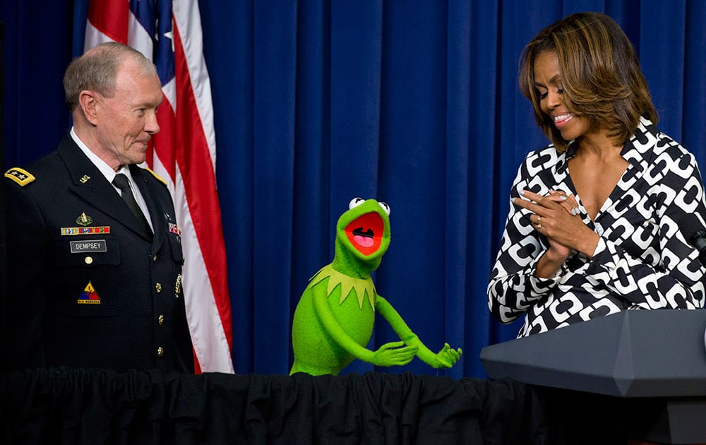 Gen. Martin Dempsey, chairman of the Joint Chiefs of Staff, left, Kermit the Frog, and first lady Michelle Obama, speak to children of military families in the South Court Auditorium of the Eisenhower Executive Office Building on the White House complex, before a screening of Disney’s `Muppets Most Wanted` movie as part of the Joining Forces initiative.
