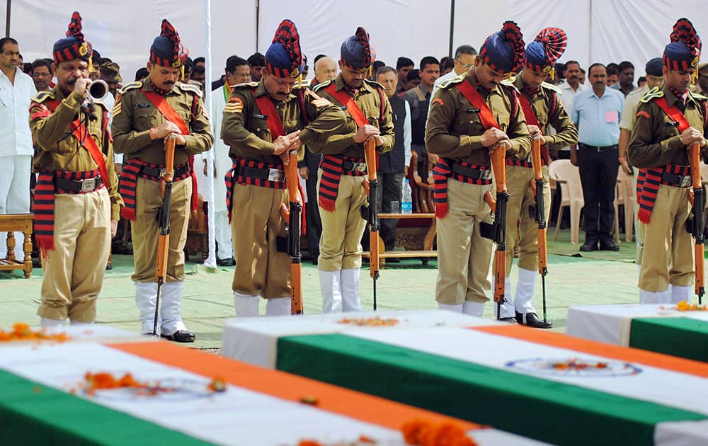 Indian security personnel pay homage to paramilitary soldiers killed in an ambush by Maoist rebels, in Jagdalpur, in the eastern Indian state of Chhattisgarh.