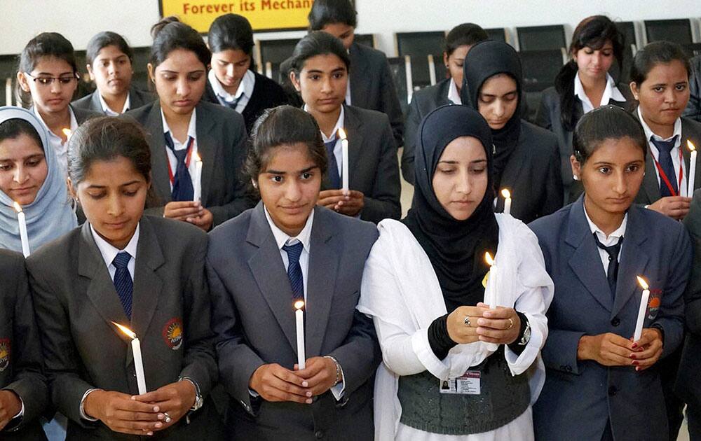 Students holding a candle light vigil praying for the safety the passenger of the missing Malaysian plane, in Mohali.