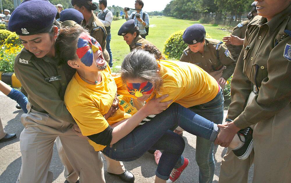 Indian police officers stop Tibetan women as they try to reach the Chinese Embassy to protest on the occasion of Women`s Uprising Day in New Delhi.