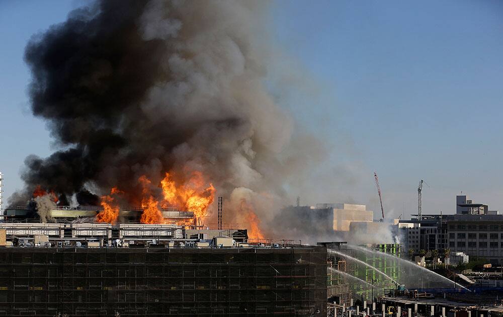Smoke rises from a fire burning in San Francisco. The major fire burning in San Francisco`s Mission Bay neighborhood sent an enormous plume of black smoke high into the sky. There were no initial reports of injuries.