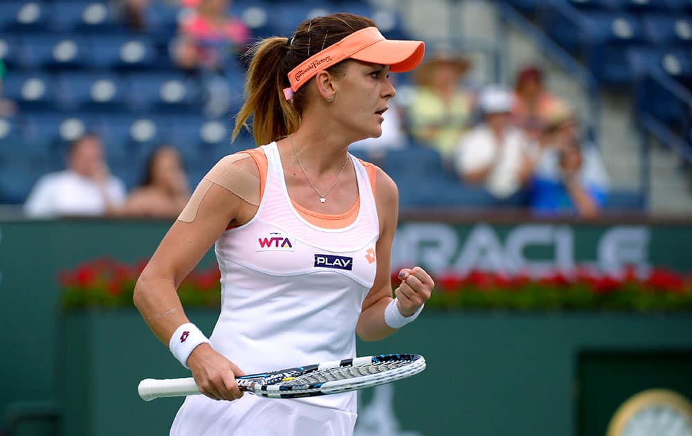 Agnieszka Radwanska, of Poland, pumps her fist after defeating Alize Cornet, of France, 7-5, 6-3, in a fourth round match at the BNP Paribas Open tennis tournament.