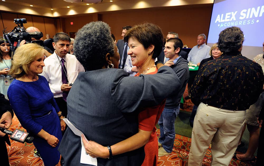 Congressional candidate Alex Sink, center, greets a supporter after giving her concession speech in St. Petersburg, Fla.