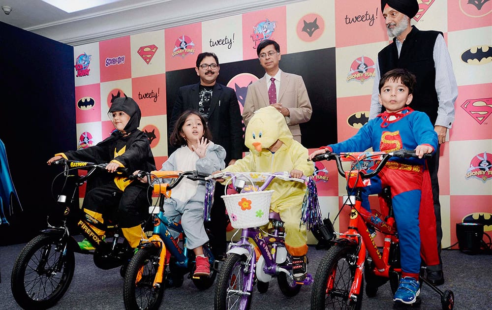 Shiv Inder Singh, MD Firefox Bikes (R) and Preston Lewis MD, Warner Bros (2nd from R) launch Firefox Superhero Bikes for kids in New Delhi.