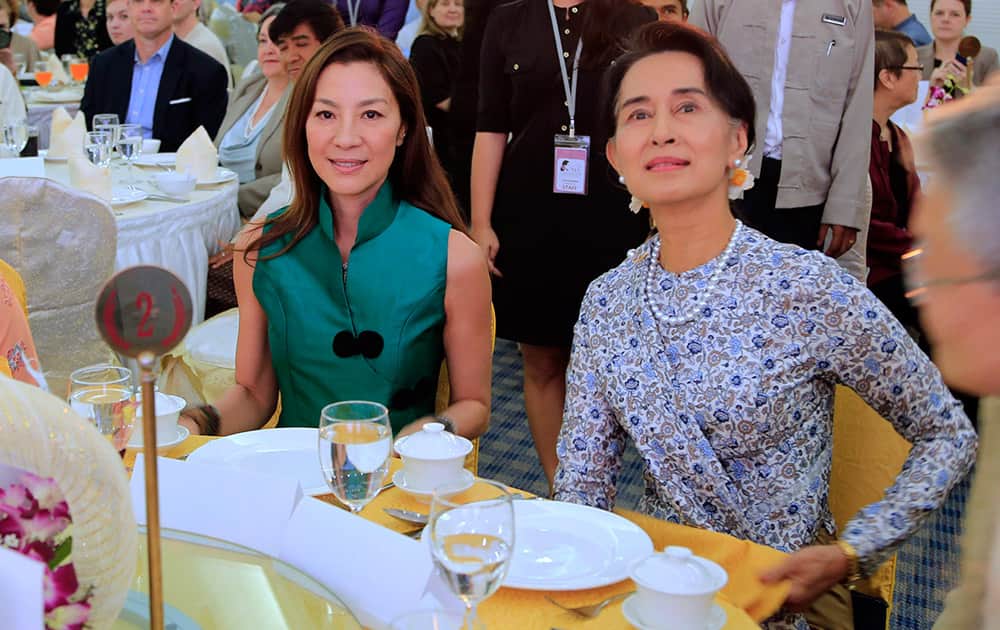 Malaysian actress Michelle Yeoh, left, sits with Myanmar opposition leader Aung San Suu Kyi during the opening ceremony of a special pre-conference in connection with the International Media Conference in Yangon, Myanmar.
