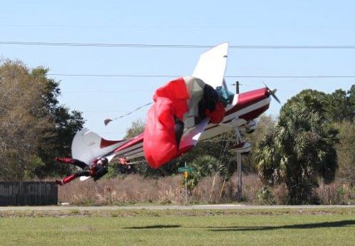 This photo released by the Polk County Sheriff`s Office shows a plane getting tangled with a parachutist, at the South Lakeland Airport in Mulberry, Fla. Both the pilot and jumper hospitalized with minor injuries.