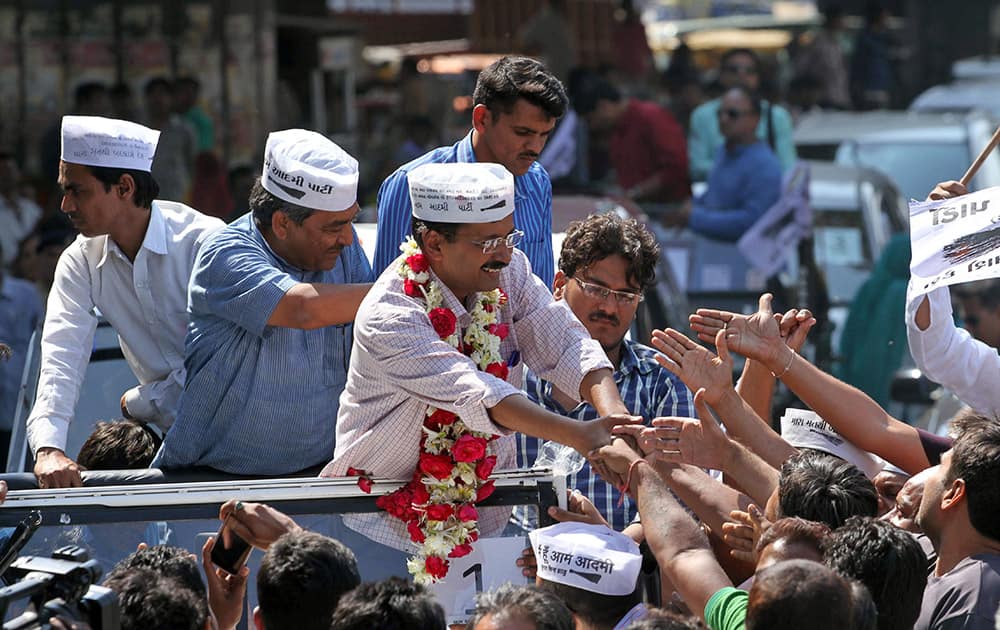Aam Aadmi Party, or Common Man Party, leader and anti-graft activist Arvind Kejriwal, center, greets supporters during an election rally in Ahmadabad, India.