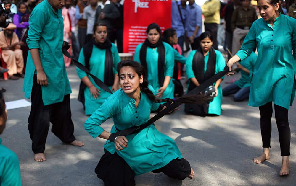 A group of college girls perform a street play on violence against women, to mark International Women`s Day in New Delhi.