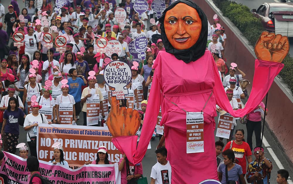 An effigy of a woman is carried by activists as they march towards the Malacanang Palace to mark International Women`s Day in Manila, Philippines.