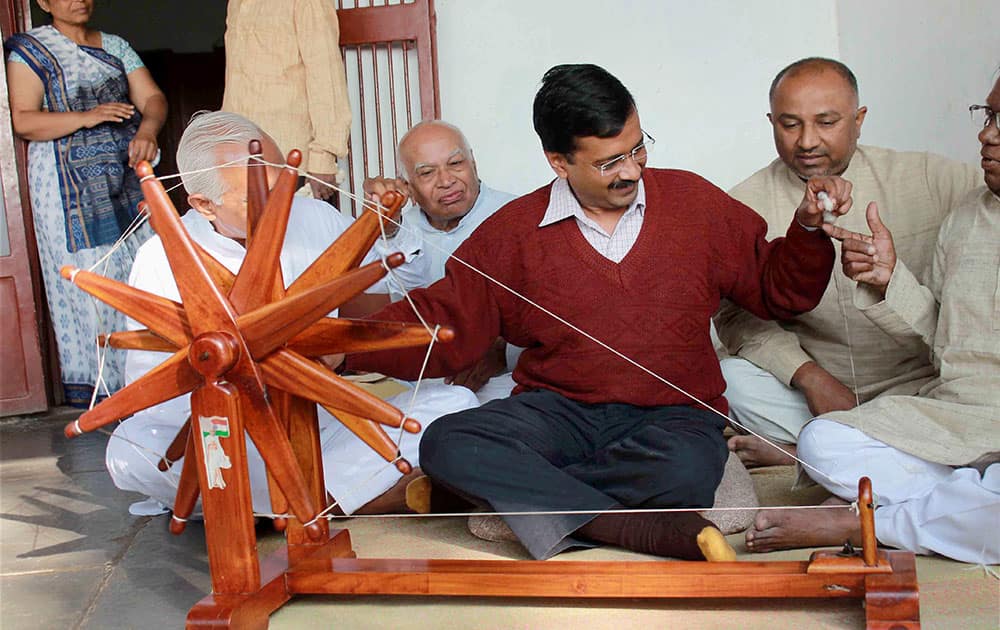 Aam Aadmi Party (AAP) convener Arvind Kejriwal trying his hands on a spinning wheel during his visit to Sabarmati Gandhi Ashram in Ahmedabad.