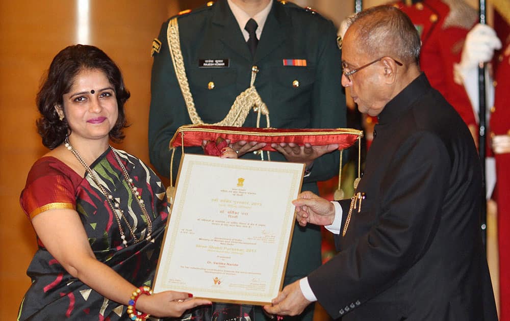 President Pranab Mukherjee presents Rani Gaidinliu Zeliang Award of `Stree Shakti Puraskar 2013` to Vartika Nanda of Delhi on International Women`s Day in New Delhi.