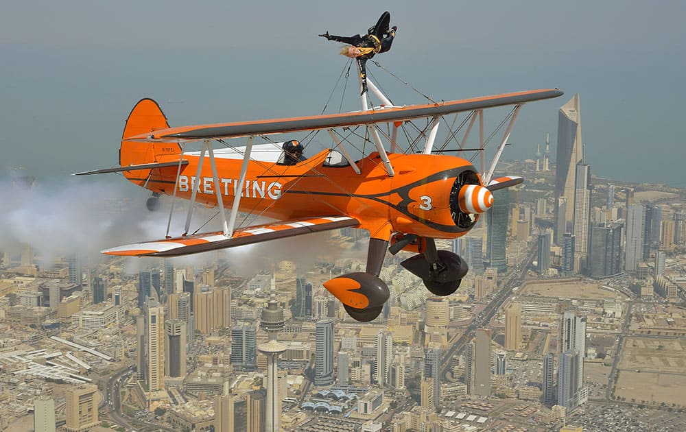 Breitling Wingwalker Freya Paterson, from Liverpool, UK, flies above Kuwait City with pilots David Barrell and Martyn Carrington.