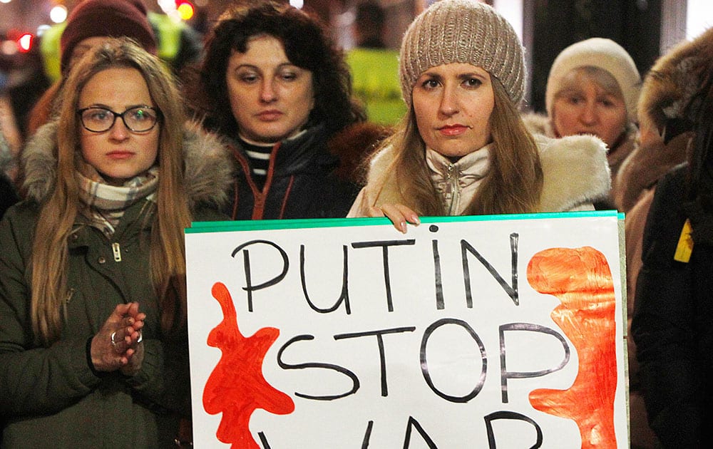Warsaw residents stage a demonstration outside the US Embassy in Warsaw, Poland, to demand sanctions against Russian leader Vladimir Putin and his government for the military incursion in Ukraine’s Crimea region.