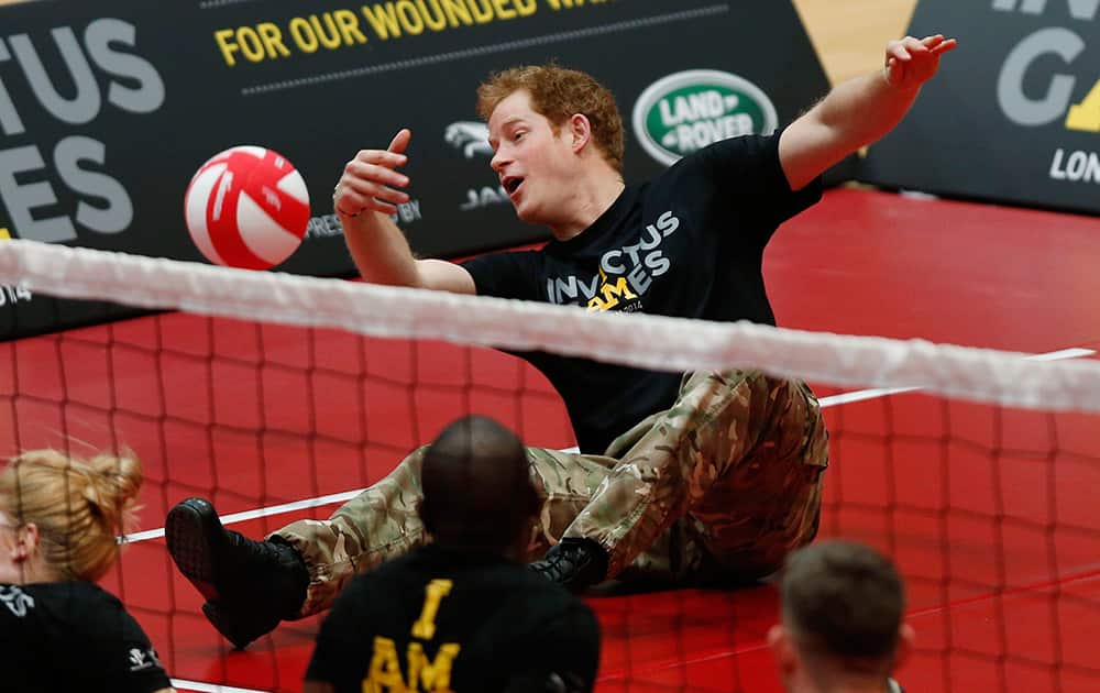 Britain Prince Harry plays a game of sitting volleyball during the launch of the Invictus Games for wounded warriors at the Copper Box arena in the Queen Elizabeth Olympic Park in London.