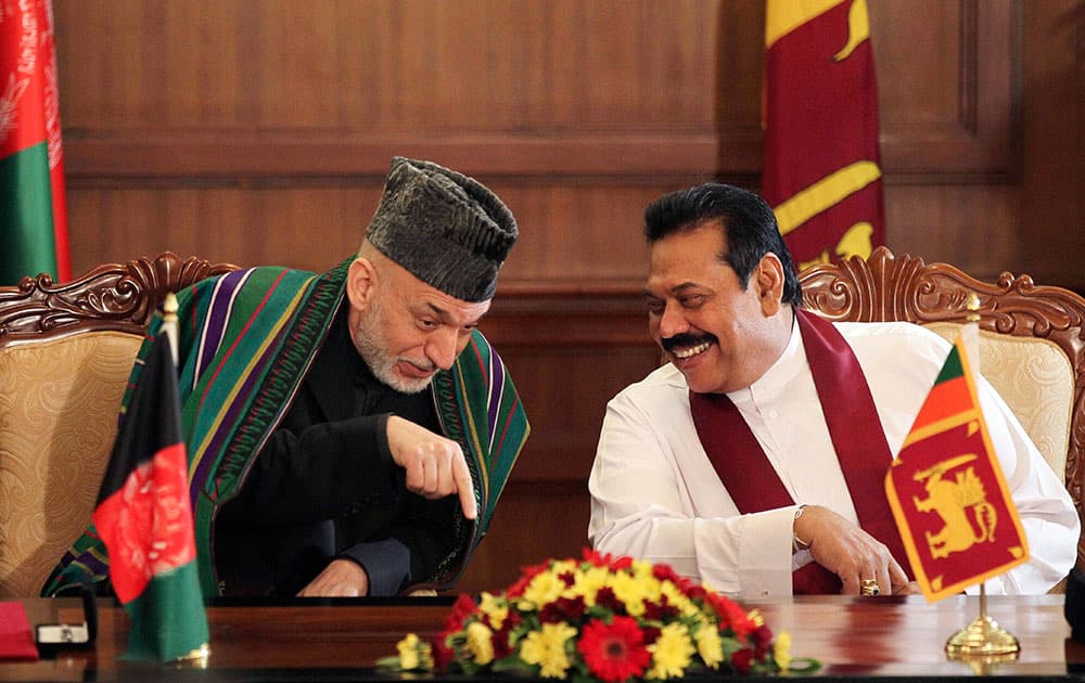 Afghan President Hamid Karzai, speaks with Sri Lankan President Mahinda Rajapaksa during their meeting in Colombo.