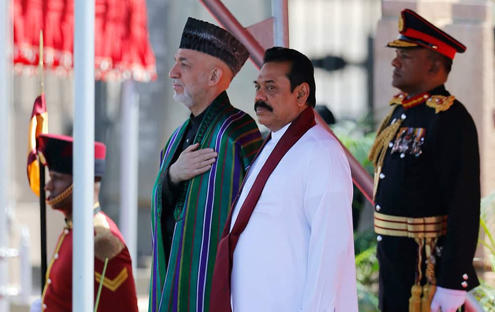 Afghan President Hamid Karzai and Sri Lankan President Mahinda Rajapaksa stand at attention during an official reception for the former in Colombo, Sri Lanka. Karzai is on a three-day official visit to Sri Lanka.