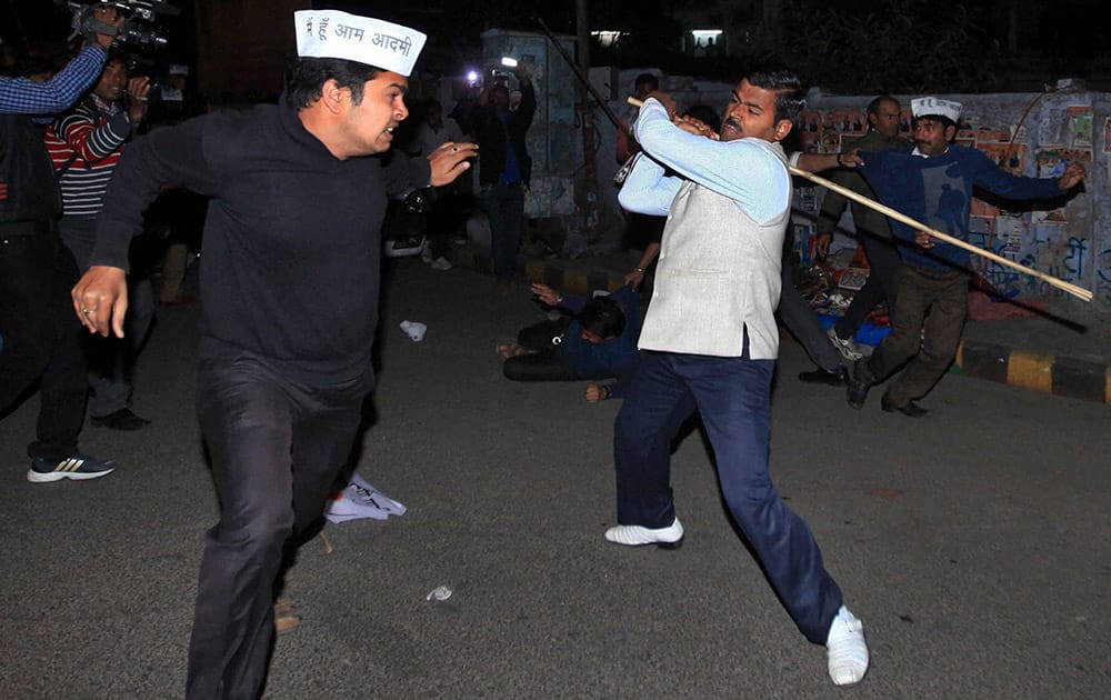 Activists of India’s opposition Bharatiya Janata Party (BJP) and those of Aam Aadmi Party, or Common Man`s Party, wearing white caps clash in Lucknow.