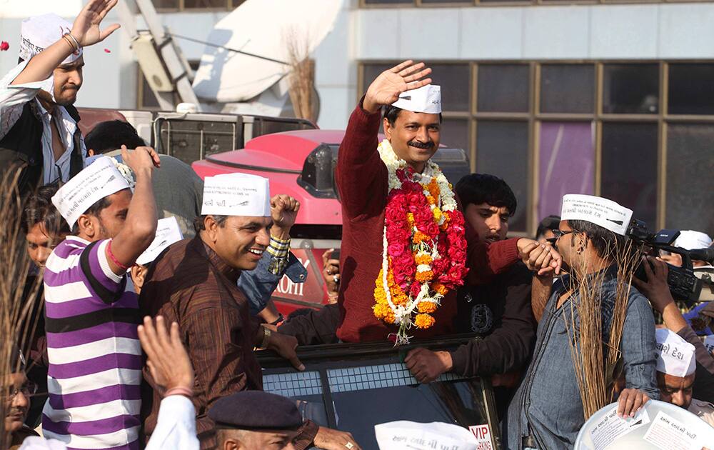 Arvind Kejriwal waves to supporters upon his arrival for a four-day visit of Gujarat state ahead of the country’s national elections, in Ahmadabad.