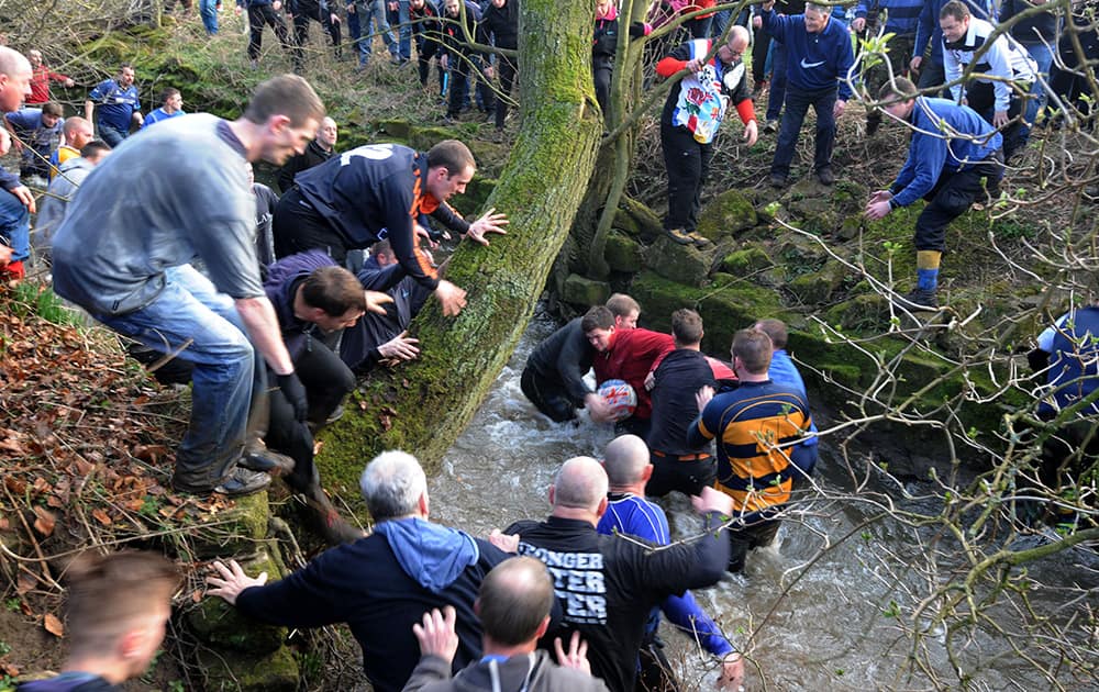Players compete for the ball during the Royal Shrovetide Football match in Ashbourne, Derbyshire England.