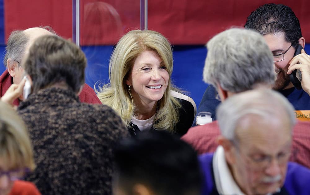 Texas Sen. Wendy Davis, D-Fort Worth, visits with volunteers manning a call center at her campaign headquarters, in Fort Worth, Texas.