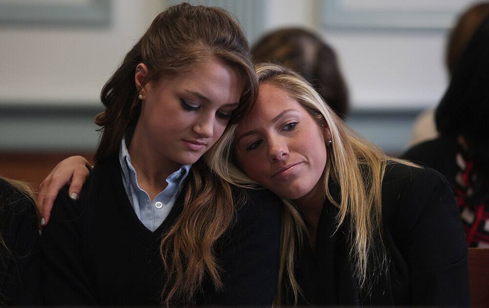 High school senior Rachel Canning, left, is comforted by friend Lauren Inglesino after seeing her father in Morris County Superior Court in Morristown, N.J.