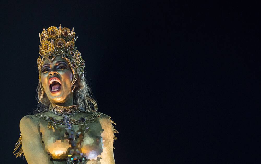 A performer from the Imperatriz Leopoldinense samba school parades on a float during carnival celebrations at the Sambadrome in Rio de Janeiro.