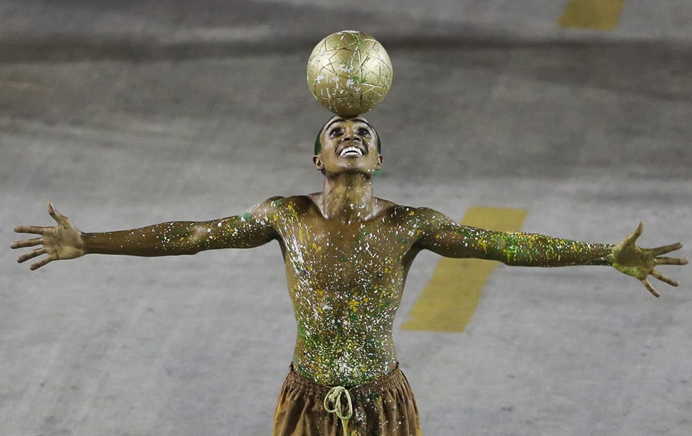 Performers from the Imperatriz Leopoldinense samba school parade during carnival celebrations at the Sambadrome in Rio de Janeiro.