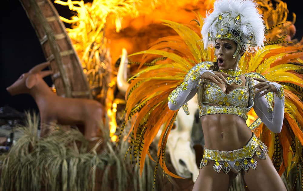 A performer from the Vila Isabel samba school parades during carnival celebrations at the Sambadrome in Rio de Janeiro, Brazil.