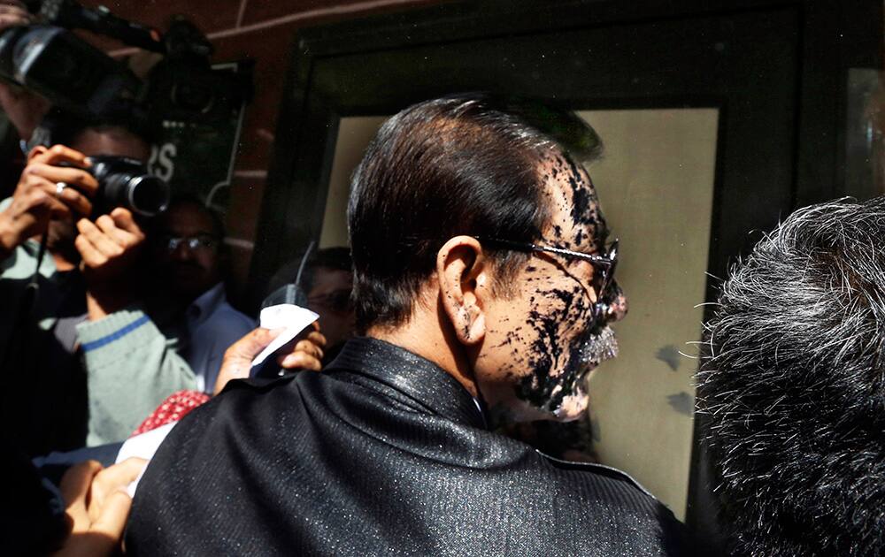 Chairman of Sahara India Pariwar Subrata Roy, his face smeared with ink thrown by a lawyer, walks into the Supreme Court in New Delhi.