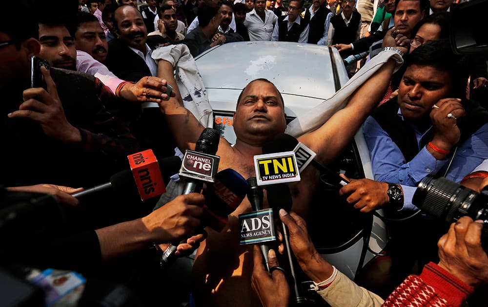 An Indian lawyer is surrounded by the media after he threw ink on Chairman of Sahara India Pariwar Subrata Roy outside the Supreme Court in New Delhi.