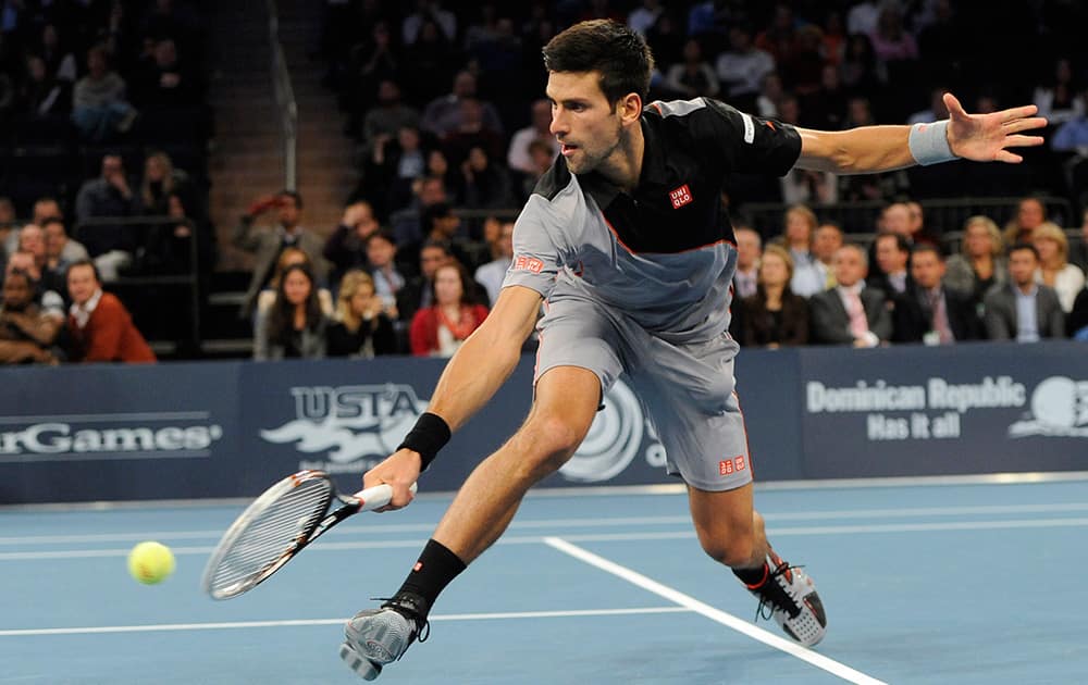 Novak Djokovic stretches to return against Andy Murray in the BNP Paribas Showdown Tennis Tournament.