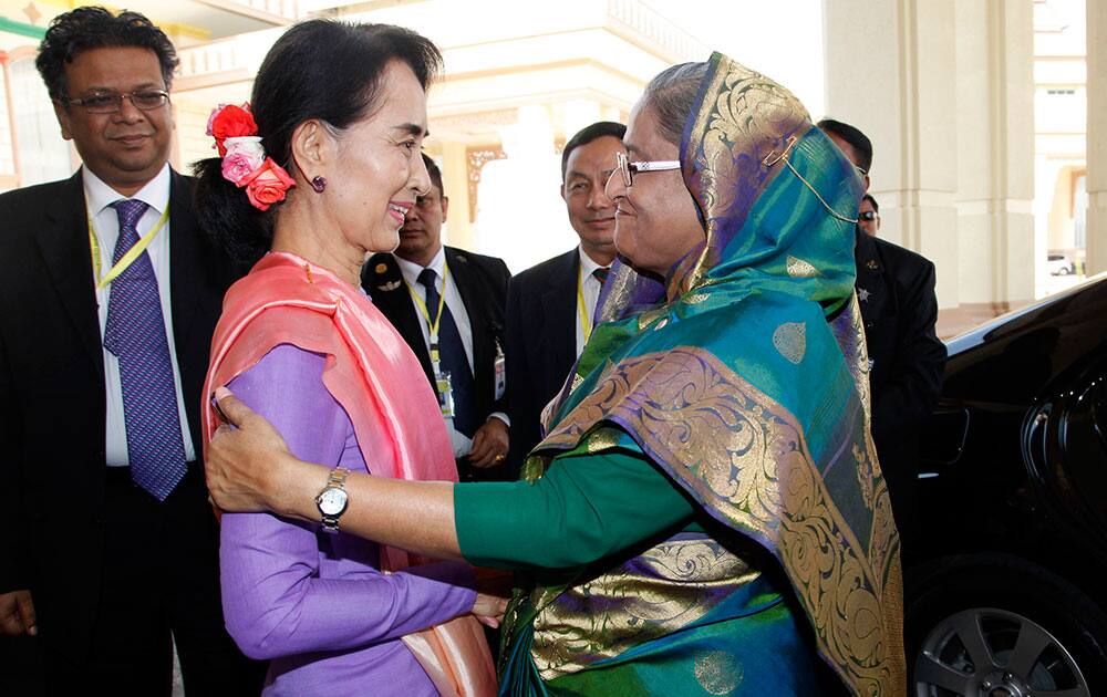 Myanmar opposition leader Aung San Suu Kyi, left, sees off Bangladesh Prime Minister Sheikh Hasina, right, after their meeting at the parliament building in Naypyitaw, Myanmar.