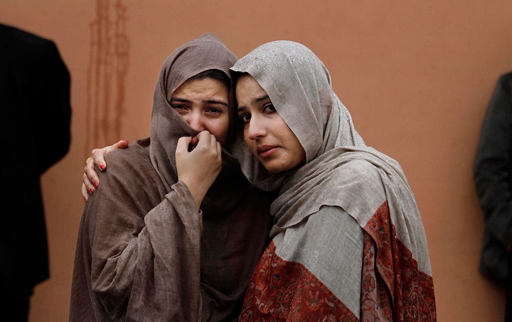 Pakistani women mourn outside a hospital`s morgue, where the bodies of victims of a twin suicide bombing are, in Islamabad, Pakistan.