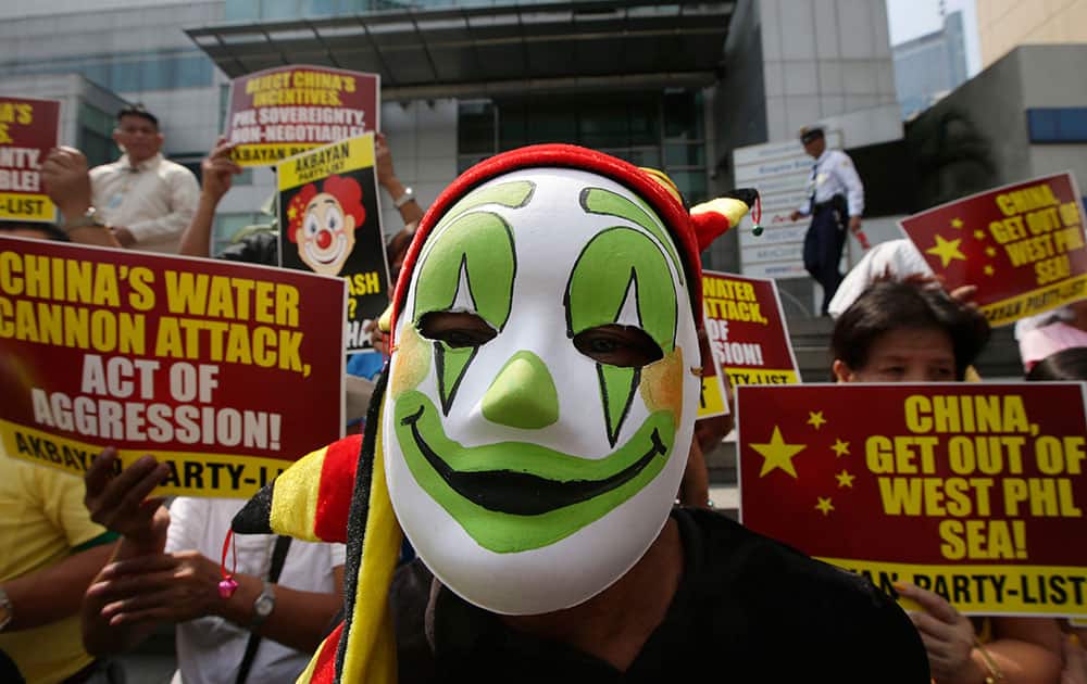 Protesters, some dressed as clowns, picket the Chinese Consulate at the financial district of Makati city east of Manila, to protest the recent use of water cannons by the Chinese coast guard to drive away Filipino fishermen off the disputed Scarborough Shoal in the South China Sea.