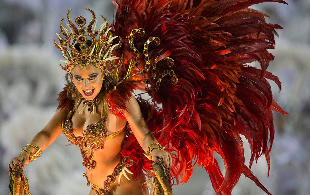 A performer from the Imperio da Tijuca samba school parades on a float during carnival celebrations at the Sambadrome in Rio de Janeiro, Brazil.