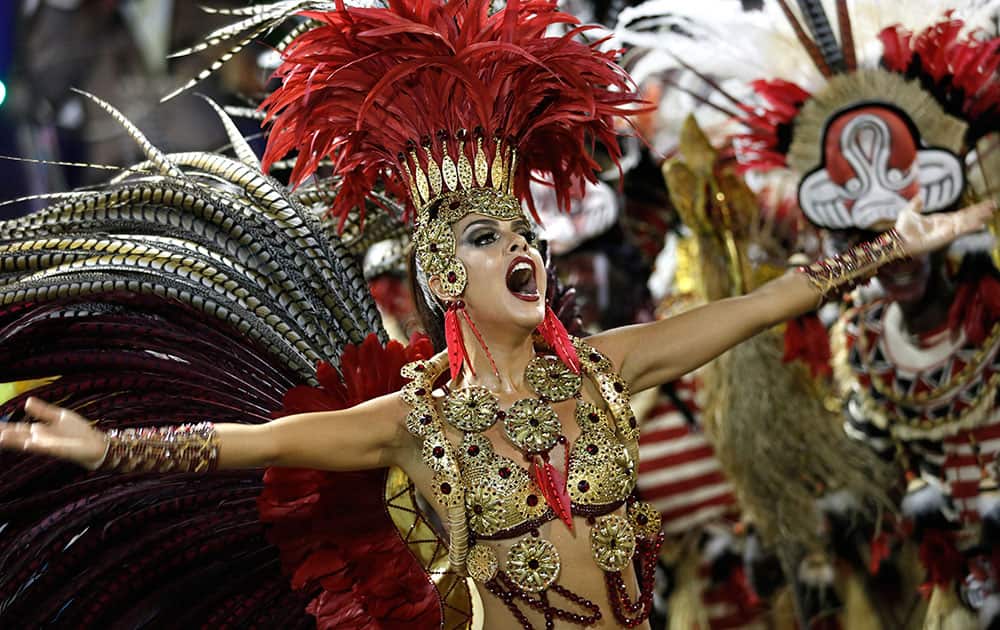 A performer from the Academicos do Grande Rio samba school parades through the Sambadrome during carnival in Rio de Janeiro, Brazil.