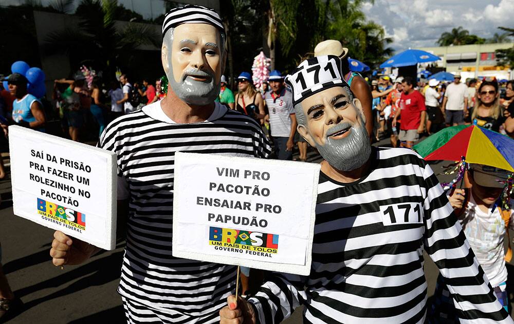 Revelers dress as prisoners and wear masks of Brazil’s former President Lula, right, and former Workers Party Treasurer Delubio Soares at the Pacotao carnival block party in Brasilia, Brazil.