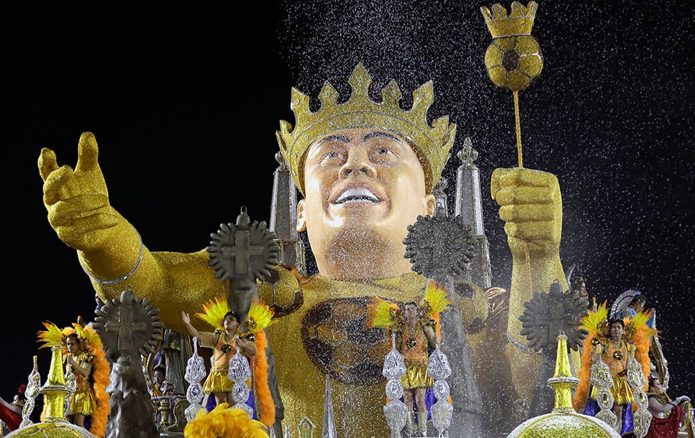 Gavioes da Fiel samba school dancers perform on their float depicting Brazil`s former soccer player Ronaldo wearing a crown at a carnival parade in Sao Paulo, Brazil.
