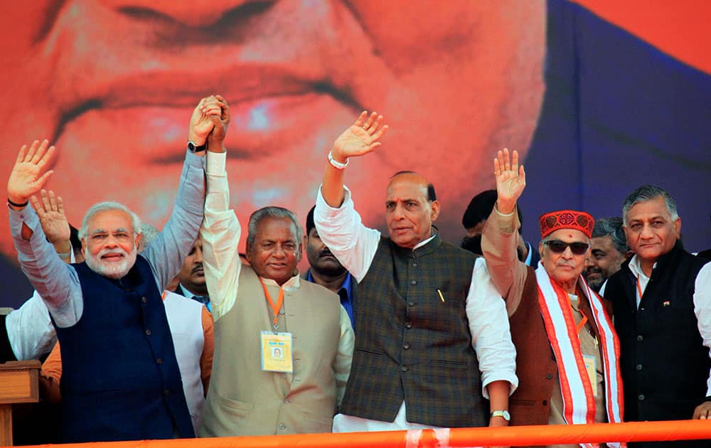 BJP Prime Ministerial candidate Narendra Modi with party President Rajnath Singh, Kalyan Singh , Murli Manohar Joshi and V K Singh waves at crowd during an election campaign rally in Lucknow.