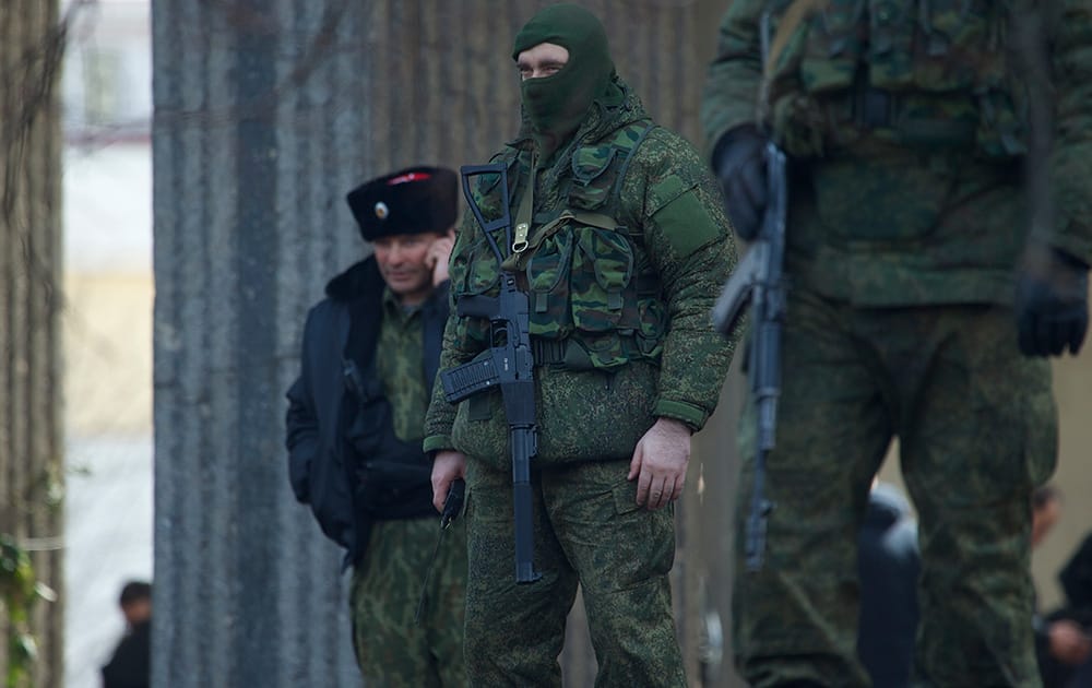 Unidentified gunmen wearing camouflage uniforms block the entrance of the Crimean Parliament building in Simferopol, Ukraine.
