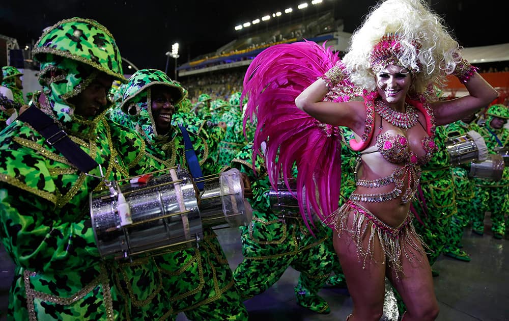 A dancer from the Academicos do Tucuruvi samba school performs during a carnival parade in Sao Paulo, Brazil.