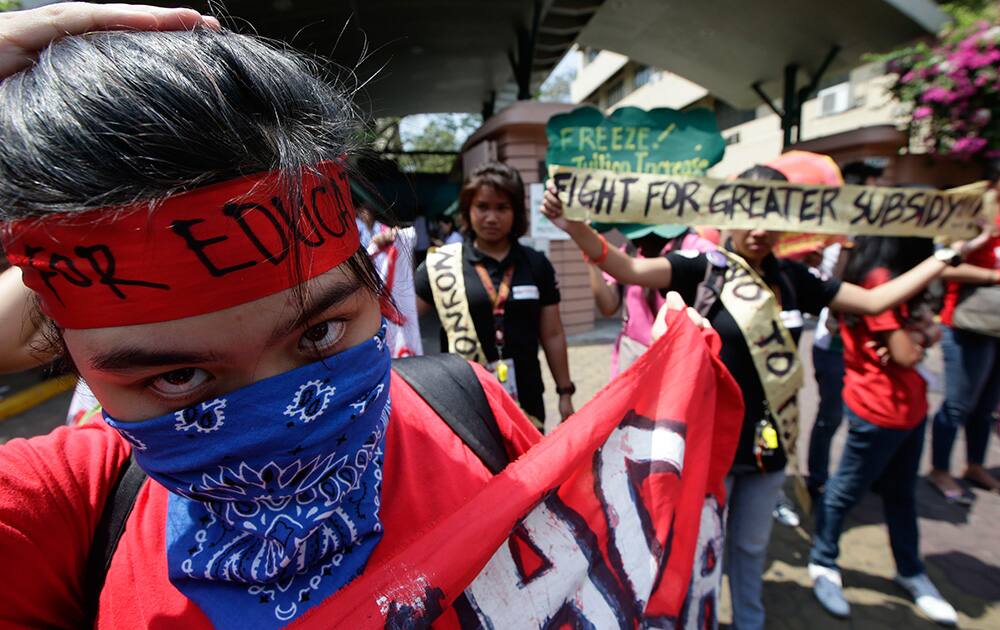 Students from different schools in Manila display placards during a rally to coincide with the last day of tuition hike consultations authorized by the Commission on Higher Education (CHED) in the country, outside a private university in Manila.