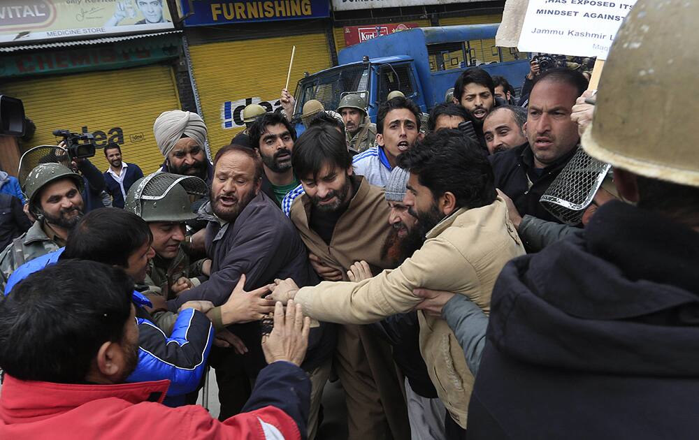 Policemen detain Jammu Kashmir Liberation Front (JKLF) chairman Yasin Malik during a protest in Srinagar.